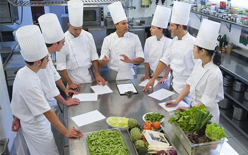 restaurant management books - restaurant employees working in a kitchen