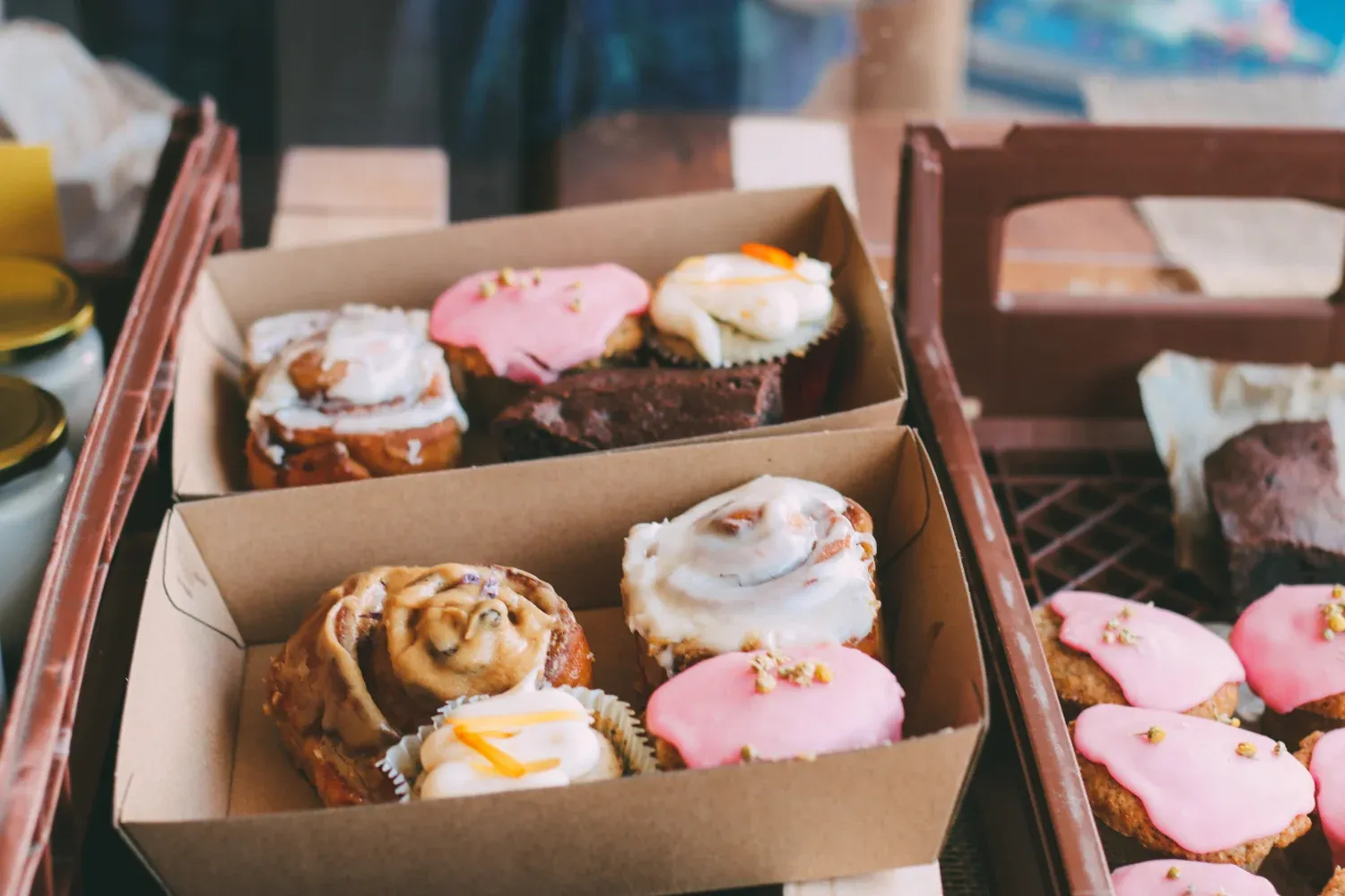 A set of pastries being packed for delivery
