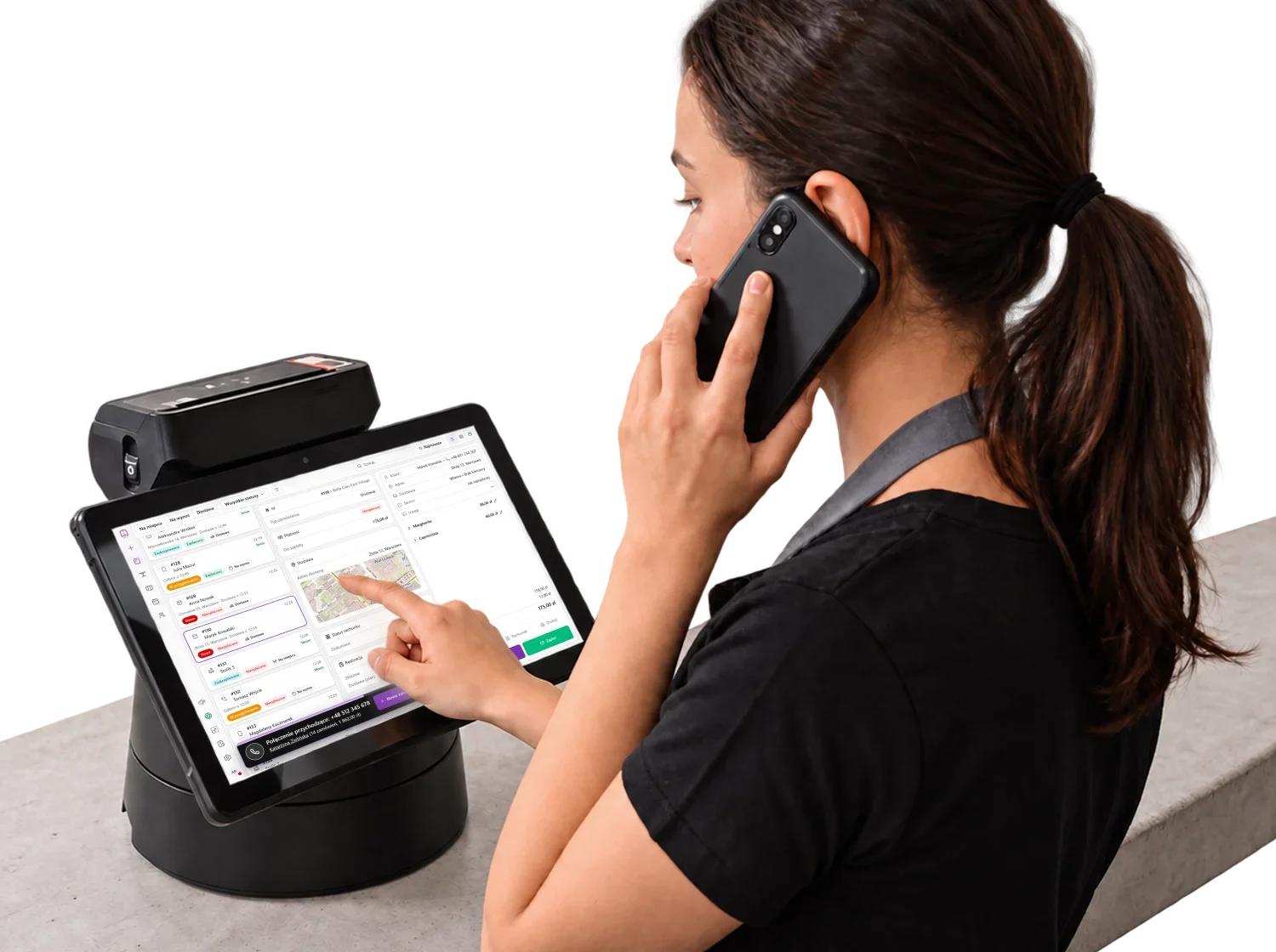 Staff member on a phone call taking the order on a POS tablet at the counter