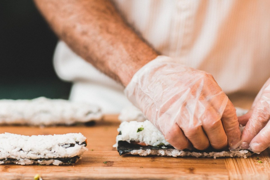 Sushi master preparing sushi rolls in ghost kitchen