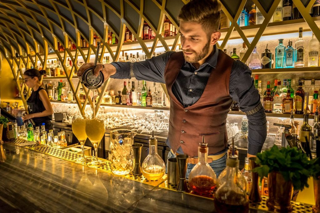 bar price - a bartender making drinks