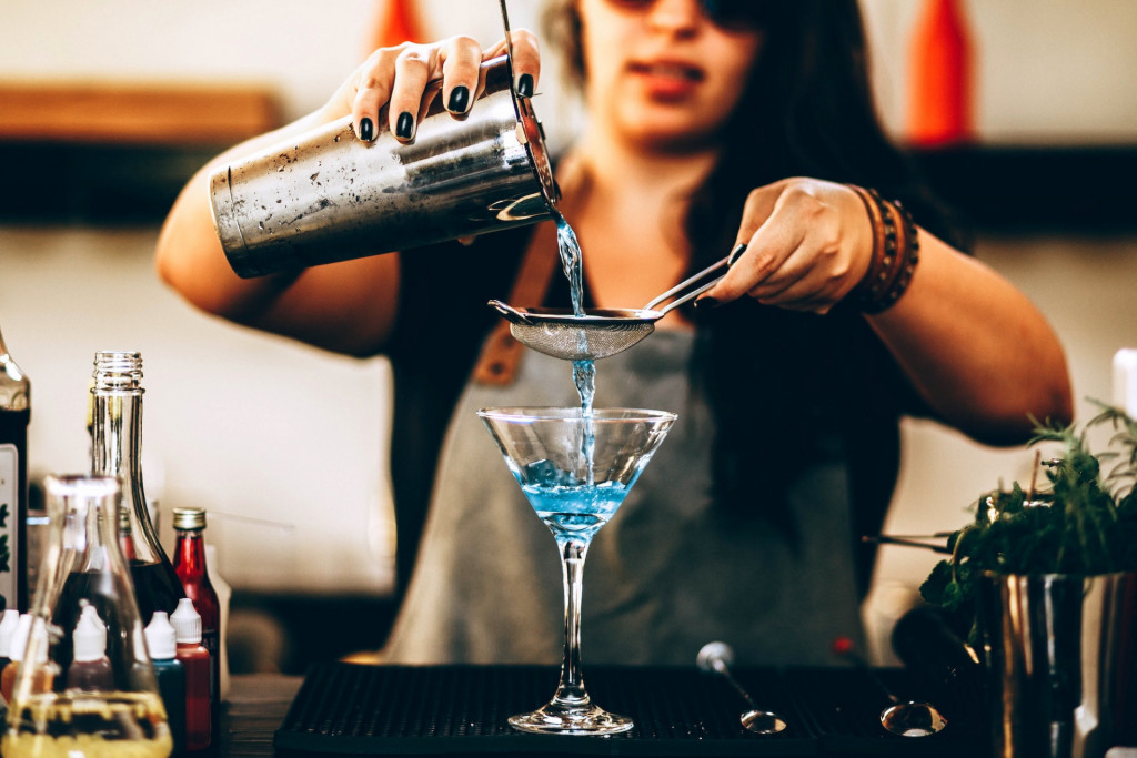how to run a bar - a bartender making a drink